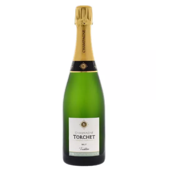 Bottiglia di Champagne LAËTITIA TORCHET Brut Tradition in servizio.